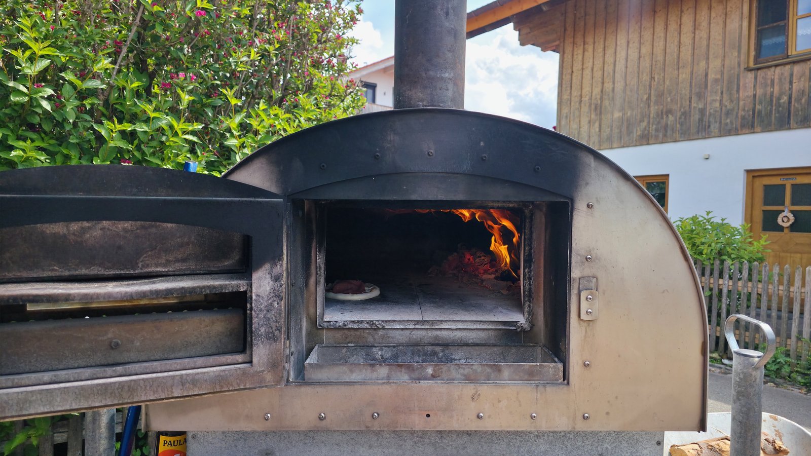 Nahaufnahme des Holzfeuers im mobilen Pizzaofen