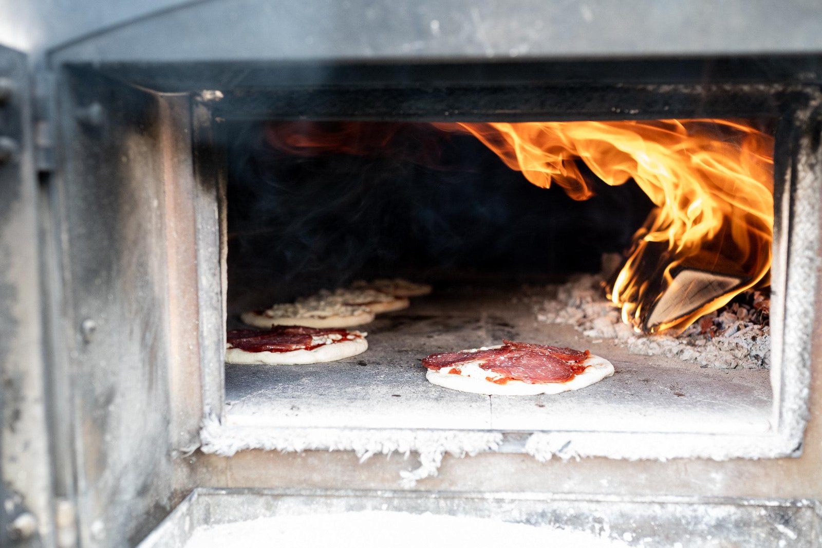 Flammen im Holzofen von Bene Pizza